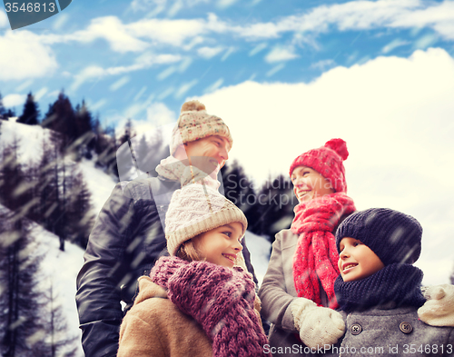 Image of happy family in winter clothes outdoors