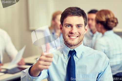 Image of group of smiling businesspeople meeting in office
