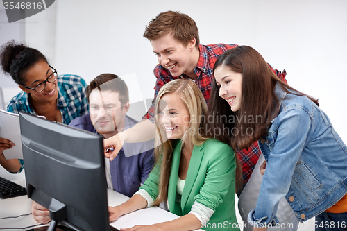 Image of happy high school students in computer class