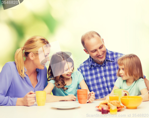 Image of happy family with two kids with having breakfast