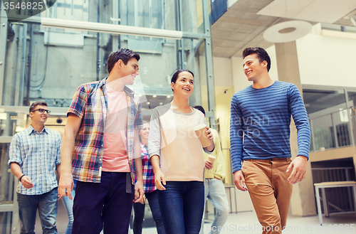 Image of group of smiling students with paper coffee cups