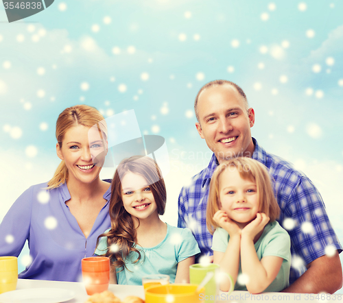 Image of happy family with two kids having breakfast