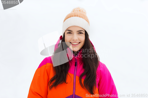 Image of happy young woman in winter clothes outdoors