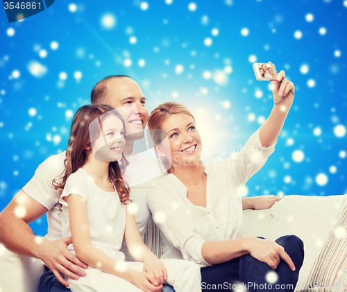 Image of happy family with camera at home