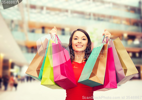 Image of smiling woman with colorful shopping bags