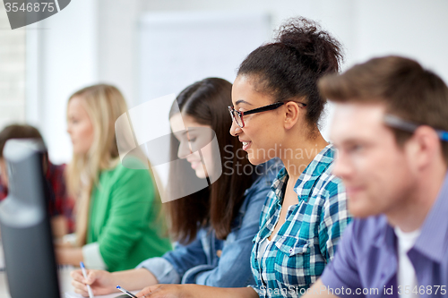 Image of happy high school students in computer class