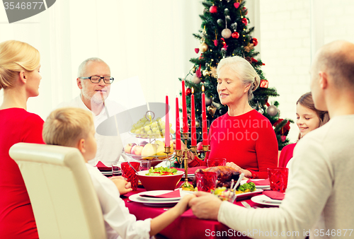 Image of smiling family having holiday dinner at home