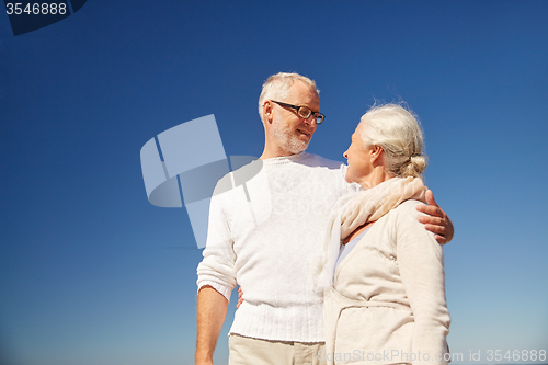 Image of happy senior couple talking outdoors