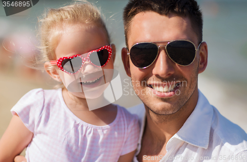 Image of happy family in sunglasses on summer beach