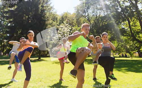 Image of group of friends or sportsmen exercising outdoors