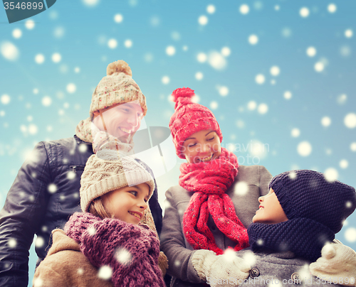 Image of happy family in winter clothes outdoors