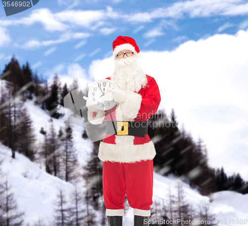 Image of man in costume of santa claus with clock