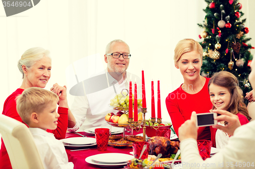 Image of smiling family having holiday dinner at home