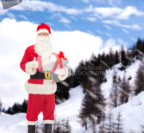 Image of man in costume of santa claus with gift box