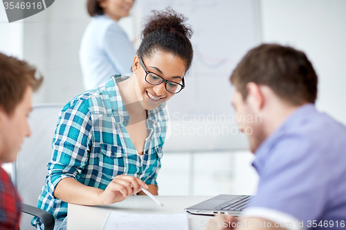 Image of group of happy high school students with workbook