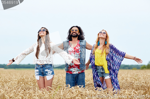 Image of smiling young hippie friends on cereal field