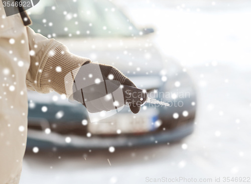 Image of close up of man with car key outdoors