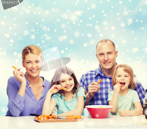 Image of happy family with two kids making dinner at home