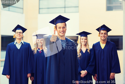 Image of group of smiling students in mortarboards