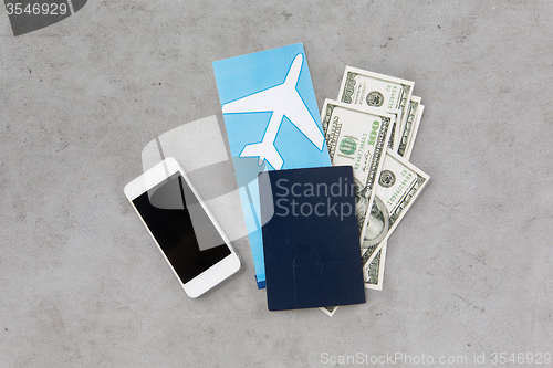 Image of air ticket, money, smartphone and passport