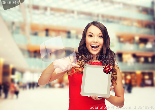 Image of smiling woman in red dress with tablet pc