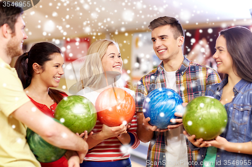 Image of happy friends in bowling club at winter season