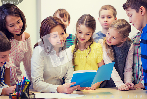 Image of group of school kids with teacher in classroom