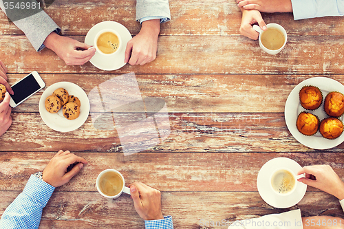 Image of close up of business team drinking coffee on lunch