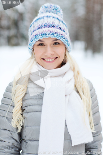 Image of smiling young woman in winter forest