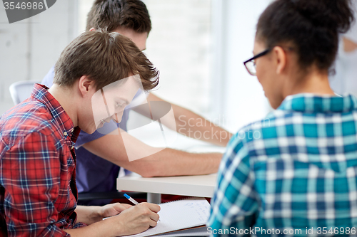 Image of group of happy high school students with workbook