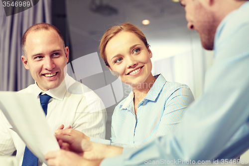 Image of business people with papers meeting in office