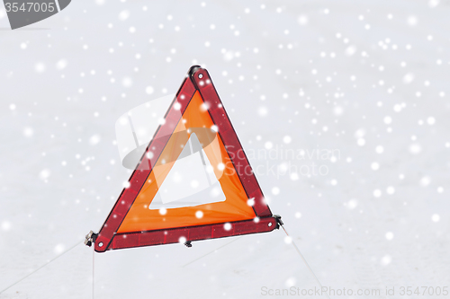 Image of closeup of warning triangle on snow