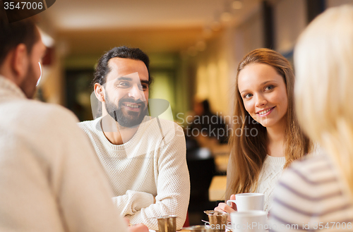 Image of happy couple meeting and drinking tea or coffee