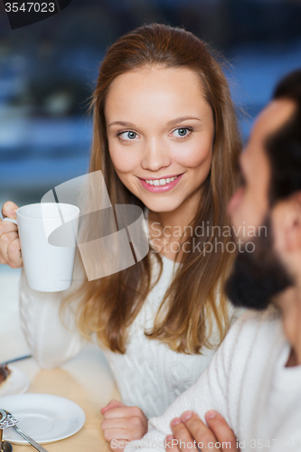 Image of happy couple meeting and drinking tea or coffee