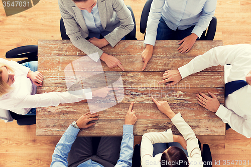 Image of close up of business team sitting at table