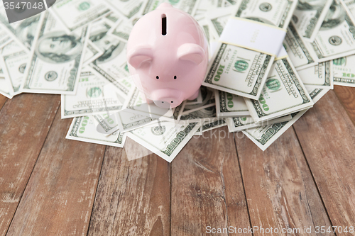 Image of close up of dollar money and piggy bank on table