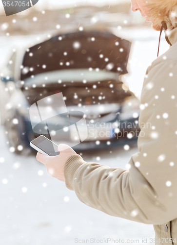 Image of closeup of man with broken car and smartphone