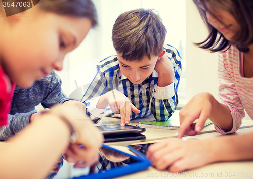 Image of group of school kids with tablet pc in classroom