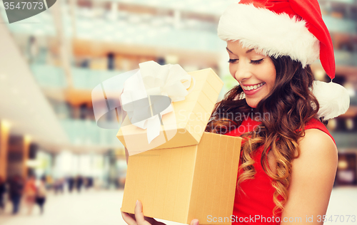 Image of smiling woman in red dress with gift box