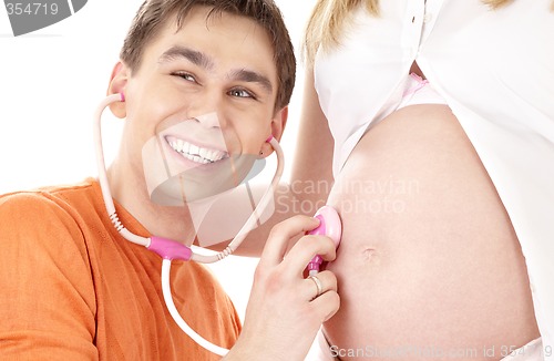 Image of happy father playing doctor