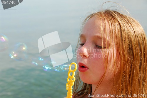 Image of Girl blowing bubbles
