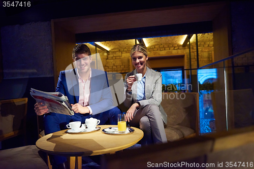 Image of business couple take drink after work