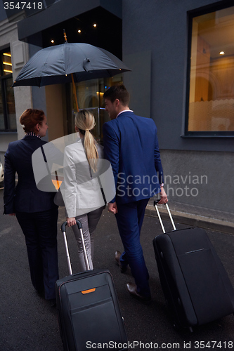 Image of business people couple entering  hotel