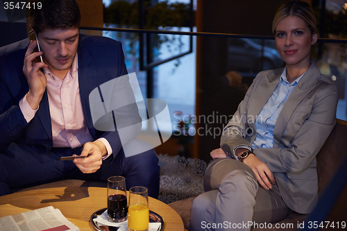 Image of business couple take drink after work