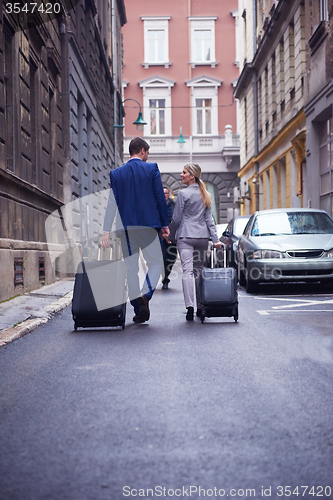 Image of business people couple entering  hotel