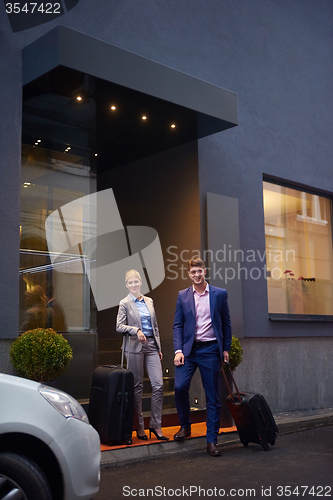 Image of business people couple entering  hotel