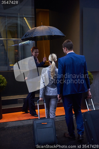 Image of business people couple entering  hotel