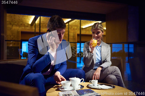 Image of business couple take drink after work