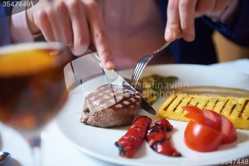 Image of business man eating tasty beef stak