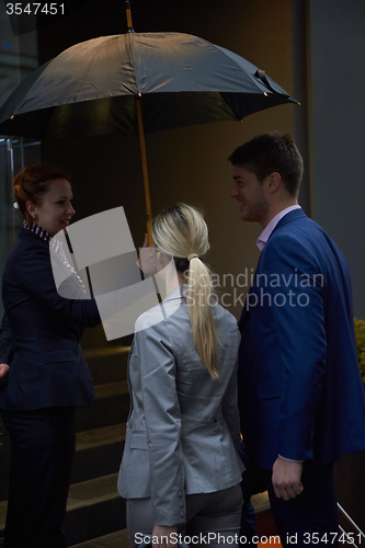 Image of business people couple entering  hotel